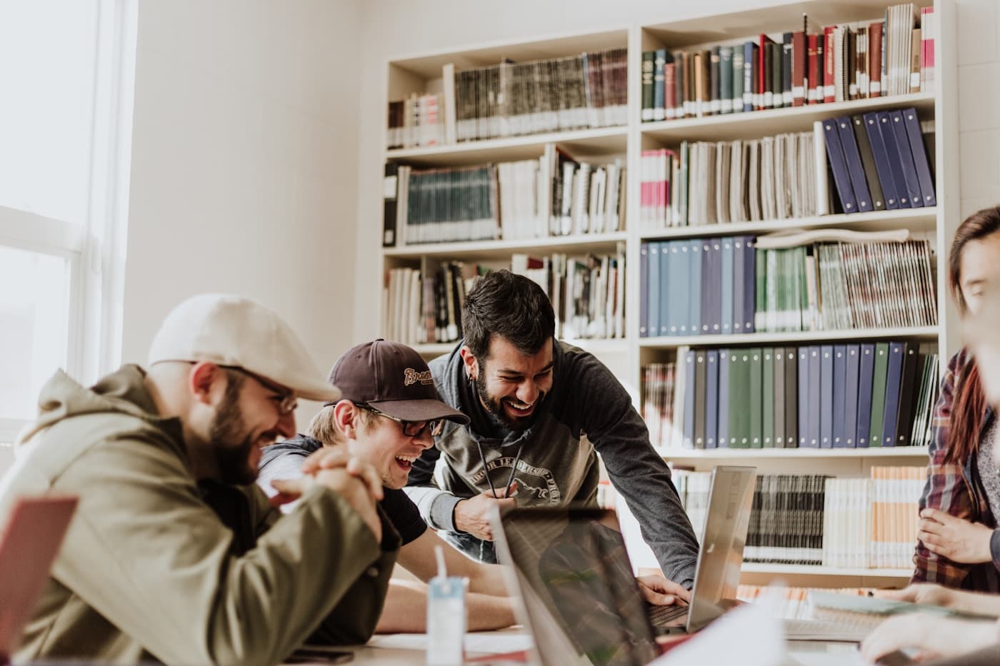 Students sharing ideas together in a university library